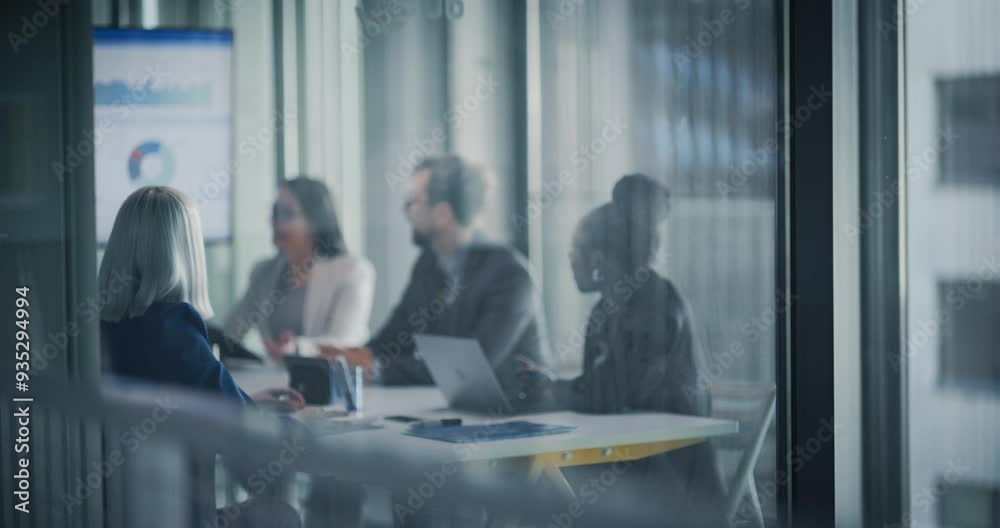 Diverse Team Engages in a Collaborative Strategic Planning Meeting in a Modern Glass-walled Conference Room. Office People Using Laptops and a Digital Whiteboard with Analytical Data