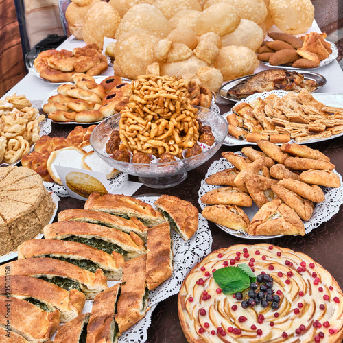 Tatar national delicacy chak chak in center of table with traditional pastries photo