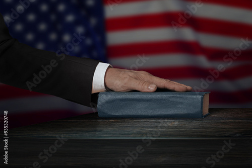 Hand on the Bible in court or the oath on the constitution book during the inauguration in parliament. Oath of Office. photo