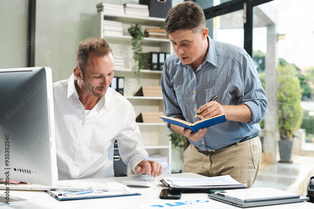 Male colleague caucasian working and update tasks with milestones progress planning and professional investor working new start up project in the office. Male colleague caucasian working and update tasks with milestones progress planning and professional investor working new start up project in the office.