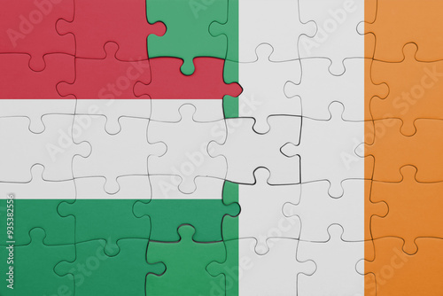 puzzle with the colourful national flag of ireland and flag of hungary. photo