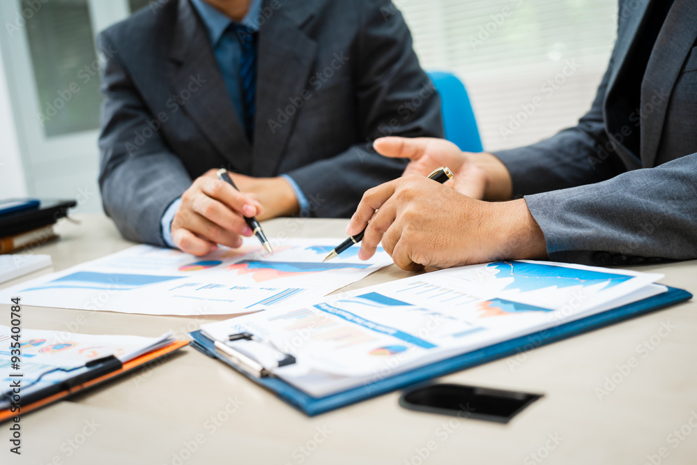 close-up of two professionals' hands meeting at a desk, discussing business strategies over a digital tablet and laptop. teamwork, planning, and communication in a corporate office setting. close-up of two professionals' hands meeting at a desk, discussing business strategies over a digital tablet and laptop. teamwork, planning, and communication in a corporate office setting.