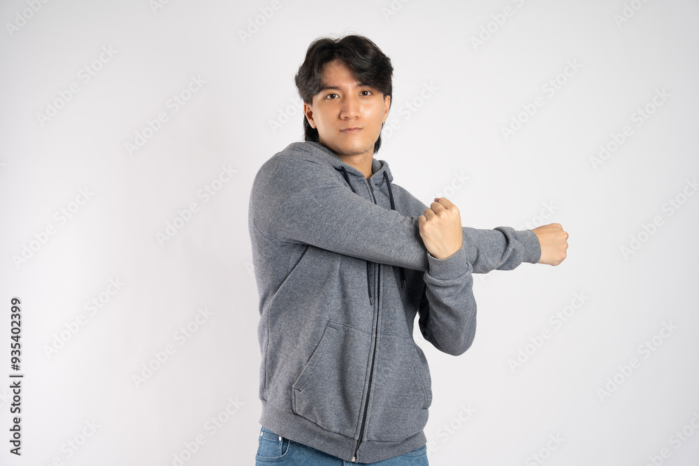 Portrait of asian man wearing hoodie posing on white background Portrait of asian man wearing hoodie posing on white background
