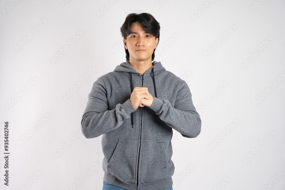 Portrait of asian man wearing hoodie posing on white background Portrait of asian man wearing hoodie posing on white background