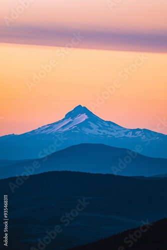 The peak of a distant mountain framed against a sunset sky