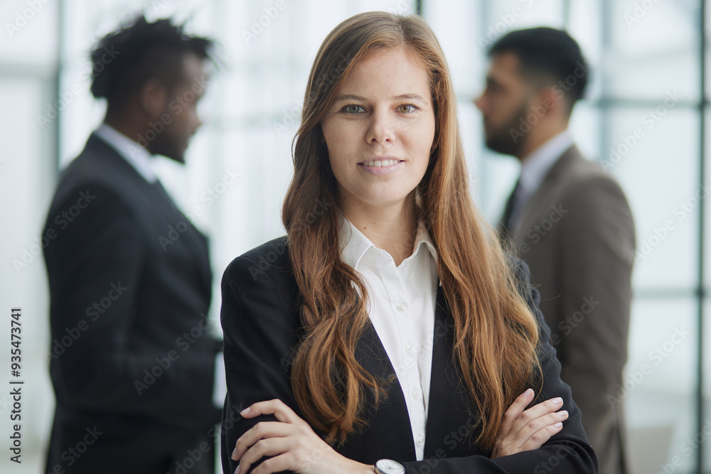 Beautiful business woman looking straight ahead with a smile Beautiful business woman looking straight ahead with a smile