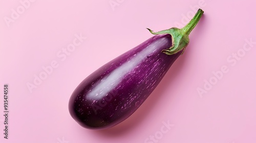 Isolated violet the eggplant alone against pink backdrop photo