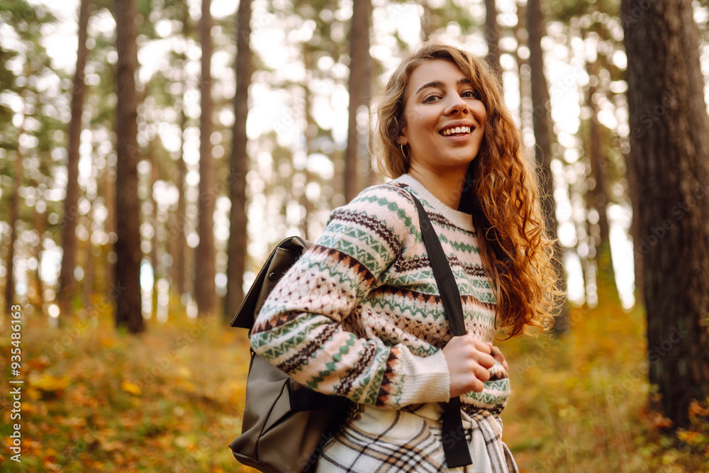 Woman enjoying a joyful moment in a sunny autumn forest surrounded by colorful leaves and towering trees Woman enjoying a joyful moment in a sunny autumn forest surrounded by colorful leaves and towering trees