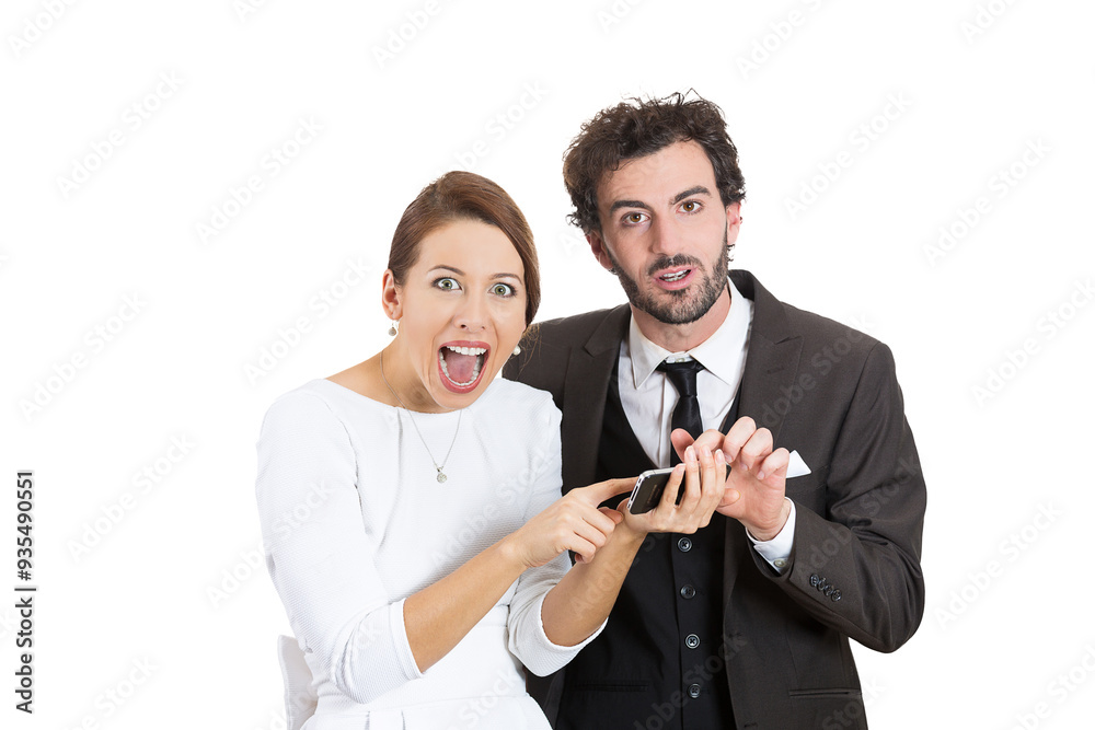 funny looking surprised couple reading news on a cellphone funny looking surprised couple reading news on a cellphone