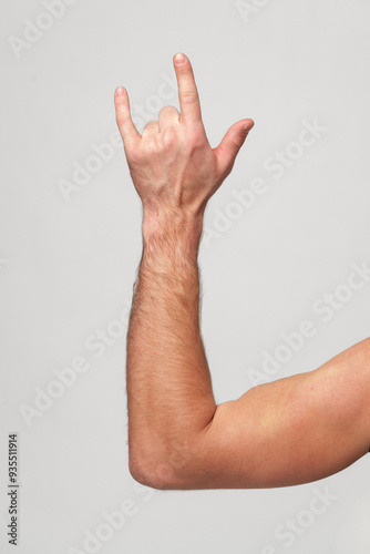 Mans Hand Showing Sign against gray background