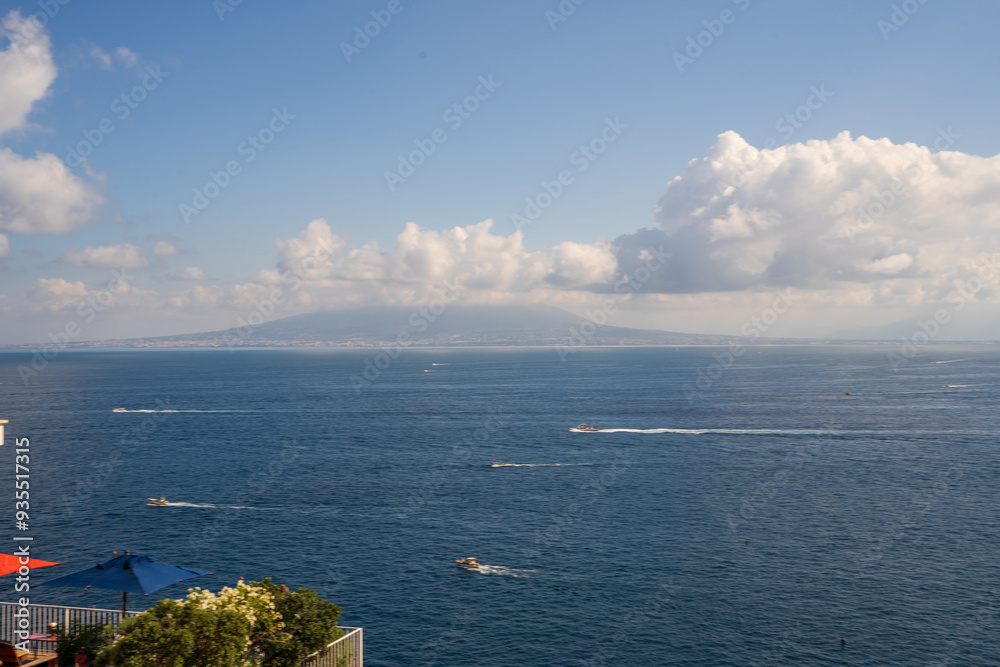 View of Sorrento and lots of boats and ship sailing showcasing Mount Vesuvius in the Background