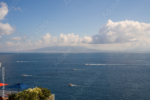 Obraz na płótnie View of Sorrento and lots of boats and ship sailing showcasing Mount Vesuvius in the Background w salonie