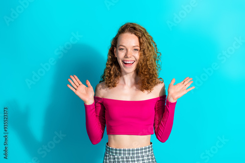 Photo of nice young girl raise hands wear pink top isolated on teal color background