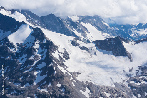 highlands landscape, mountain ranges with glaciers among clouds photo