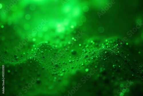 Luminous green abstract texture with glowing particles and bokeh effect