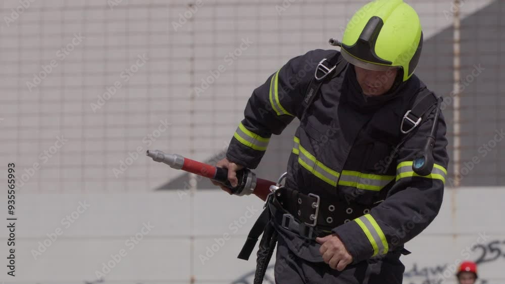 A special team of firefighters seizes hoses from a firetruck and embarks on a perilous mission to extinguish a blazing fire, showcasing their bravery and professional expertise in tackling a hazardous A special team of firefighters seizes hoses from a firetruck and embarks on a perilous mission to extinguish a blazing fire, showcasing their bravery and professional expertise in tackling a hazardous