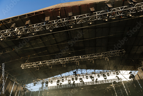 Design of spotlights hanging from rigging on the ceiling of the stage at a music festival