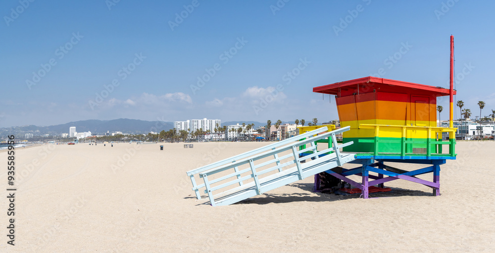 A vibrant photo of a lifeguard tower in the colors of the pride flag A vibrant photo of a lifeguard tower in the colors of the pride flag