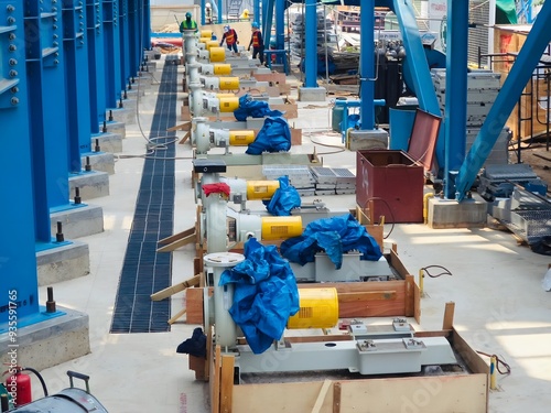 Installation of industrial machinery at a construction site. Multiple units are being aligned and prepared for operation. The image captures the scale and precision of industrial projects.