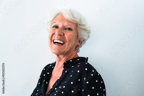 Beautiful senior old woman with gray hair portrait at home - Youthful elderly granmother spending quality time at home photo