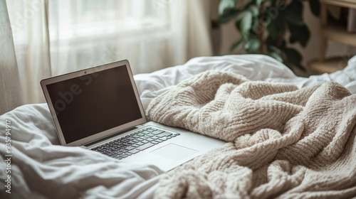 A laptop on the bed.