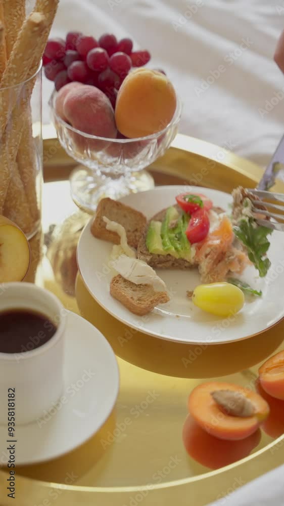 Enjoying a Healthy Continental Breakfast in Bed with Fresh Fruits and Coffee. Vertical video Enjoying a Healthy Continental Breakfast in Bed with Fresh Fruits and Coffee. Vertical video