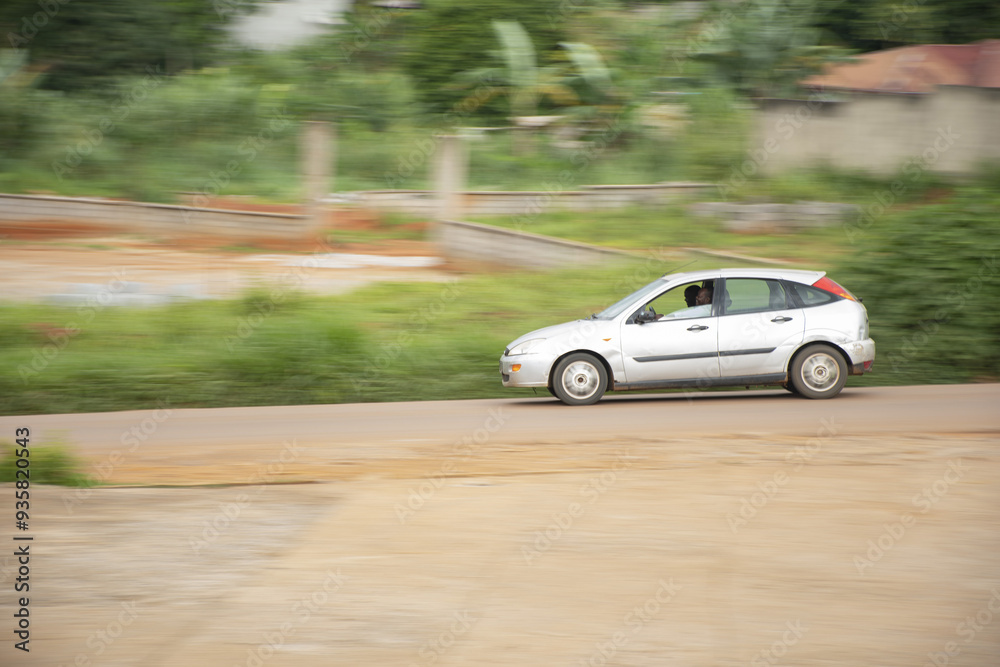 car on the road, Small car speeding down a Yaounde street