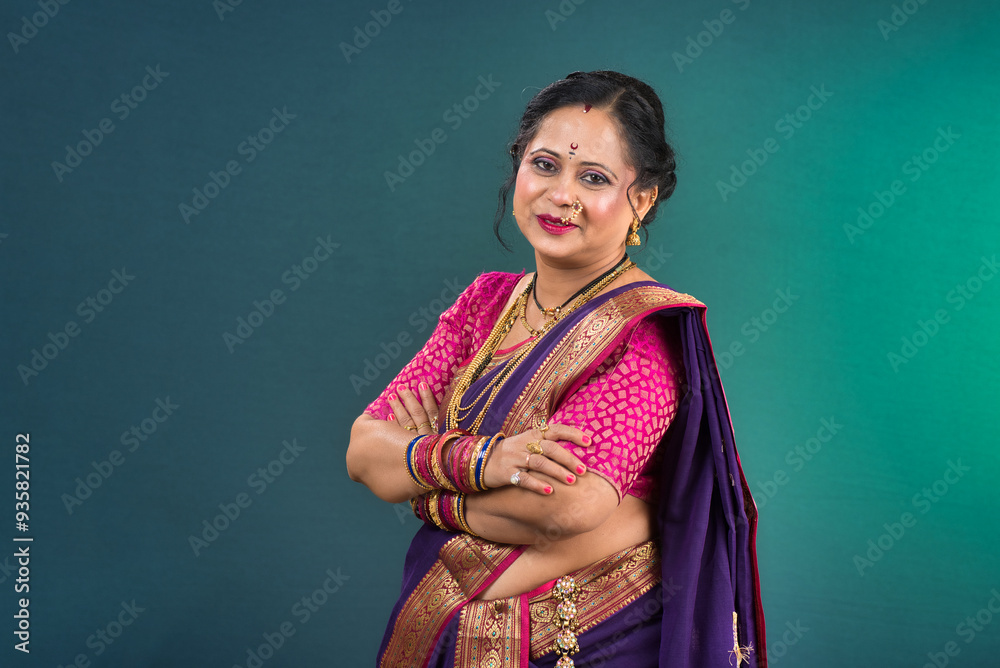 Portrait of traditional Indian woman wearing saree posing with hands fold Portrait of traditional Indian woman wearing saree posing with hands fold