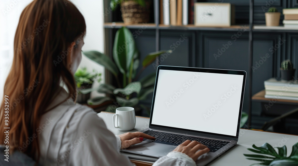 Woman using laptop at home office blank screen mockup lateral view Woman using laptop at home office blank screen mockup lateral view