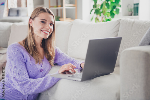 Photo of nice young girl sit floor netbook working eshopping wear violet clothes modern cozy interior flat indoors