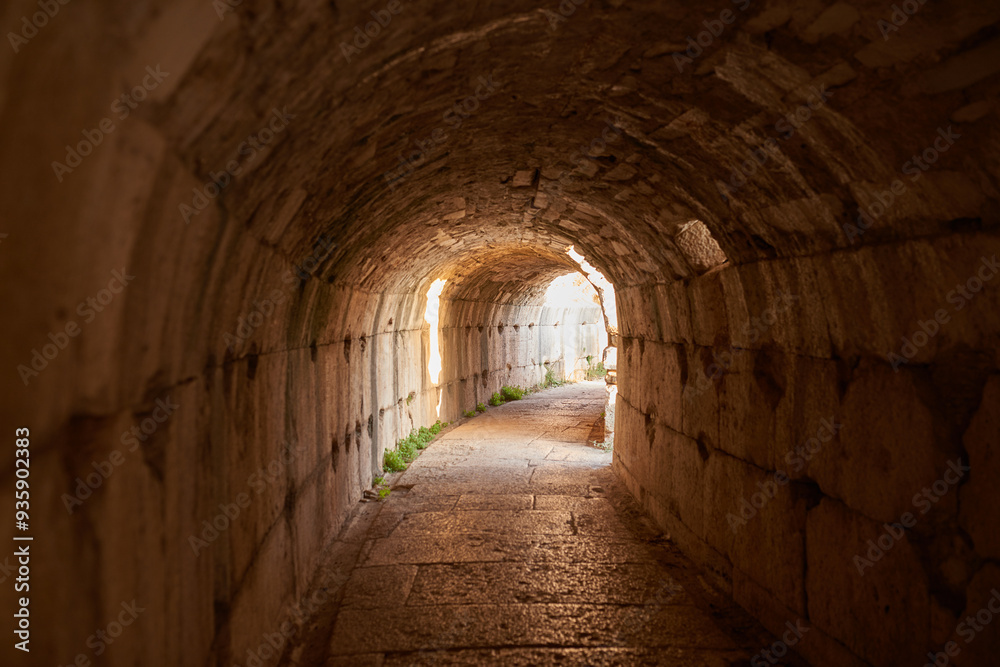 Travel, tunnel and ancient architecture in Greece as old building, structure and history at destination. Landmark, monument and empire with tourism, culture and art for discovery, adventure and site Travel, tunnel and ancient architecture in Greece as old building, structure and history at destination. Landmark, monument and empire with tourism, culture and art for discovery, adventure and site