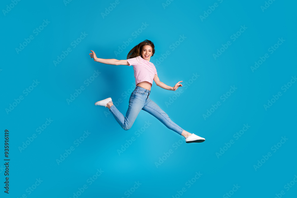 Fototapeta premium Full body photo of attractive young woman running hurry black friday dressed stylish striped pink clothes isolated on blue color background