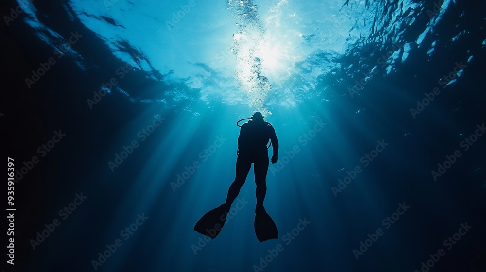 Silhouette of a Diver Ascending Towards Sunlight Silhouette of a Diver Ascending Towards Sunlight
