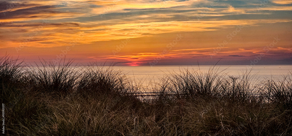 sunset at the beach sand dunes grass