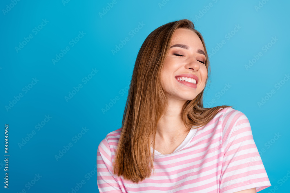 Photo portrait of attractive young woman deamy sweet girlfriend dressed stylish striped pink clothes isolated on blue color background Photo portrait of attractive young woman deamy sweet girlfriend dressed stylish striped pink clothes isolated on blue color background