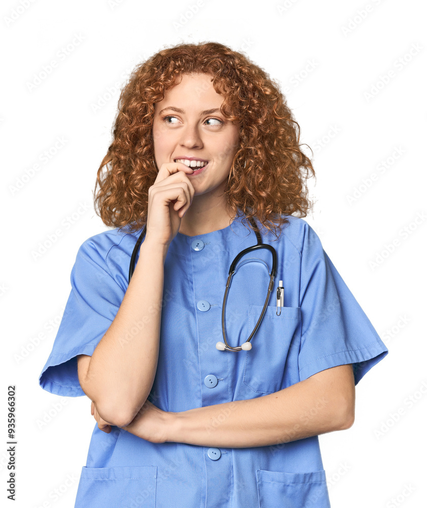 Young Caucasian redhead woman as nurse relaxed thinking about something looking at a copy space. Young Caucasian redhead woman as nurse relaxed thinking about something looking at a copy space.