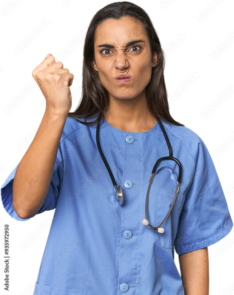 Hispanic nurse in uniform with stethoscope showing fist to camera, aggressive facial expression. Hispanic nurse in uniform with stethoscope showing fist to camera, aggressive facial expression.