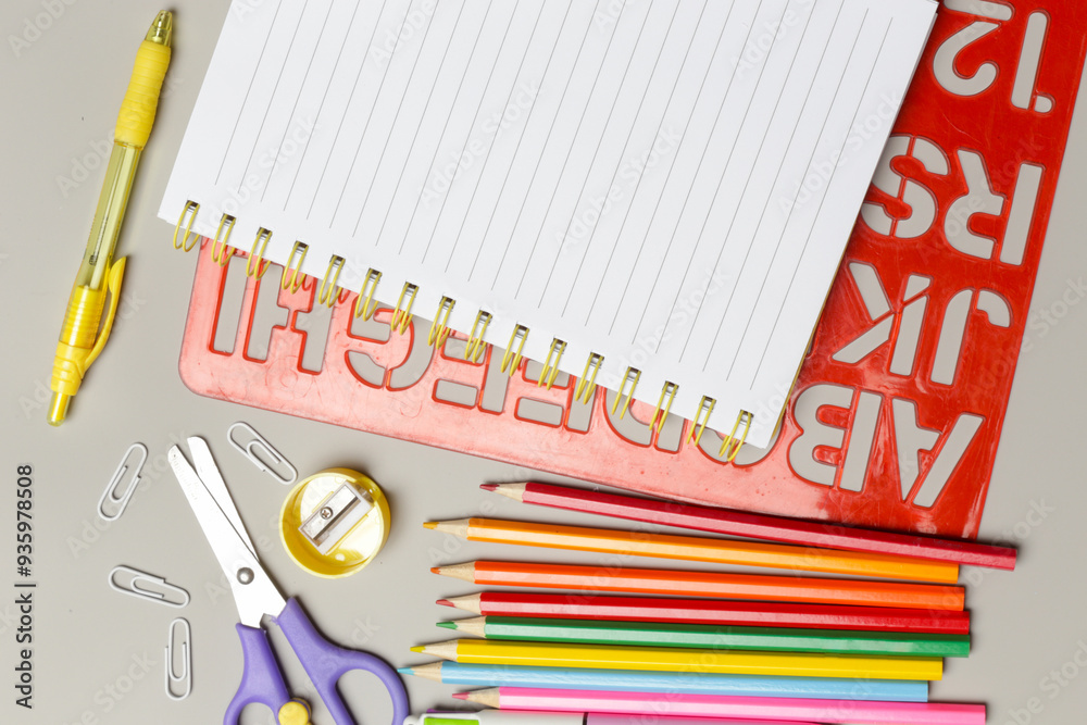 Back to school concept with variety of office and school supplies on grey background. Back to school concept with variety of office and school supplies on grey background.