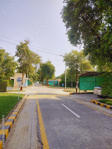 parking area of unilever estate residential area of rahim yar khan, society area road urban city with tree road and cloudy weather	 photo