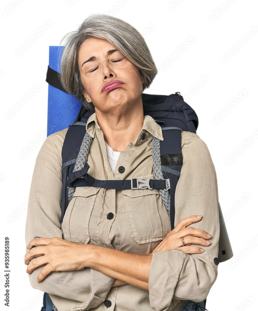 Caucasian mid-age female with hiking gear tired of a repetitive task. Caucasian mid-age female with hiking gear tired of a repetitive task.