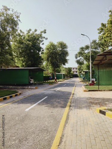 parking area of unilever estate residential area of rahim yar khan, society area road urban city with tree road and cloudy weather	 photo