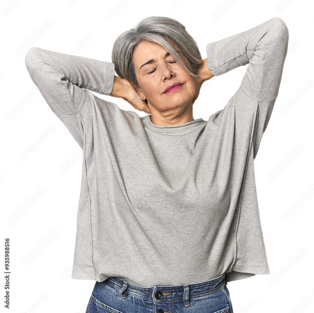 Caucasian mid-age female on studio background feeling confident, with hands behind the head. Caucasian mid-age female on studio background feeling confident, with hands behind the head.
