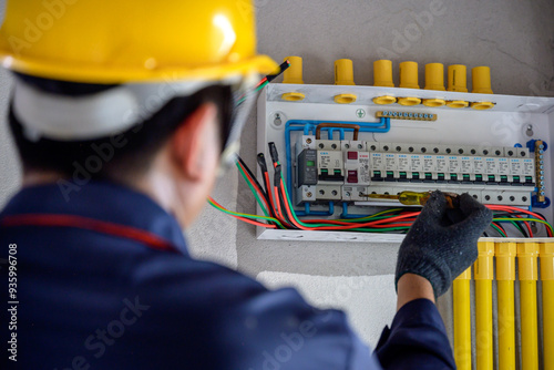 A male electrician or electrical worker Install and test electrical outlets and switches in houses and structures.