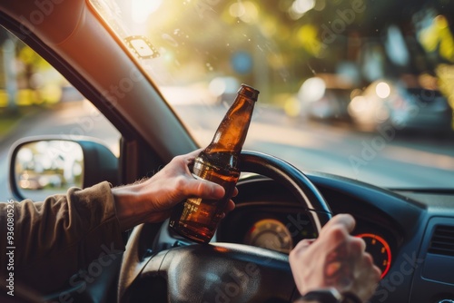 A person holding a beer bottle while driving a car, highlighting dangerous and irresponsible behavior behind the wheel. photo