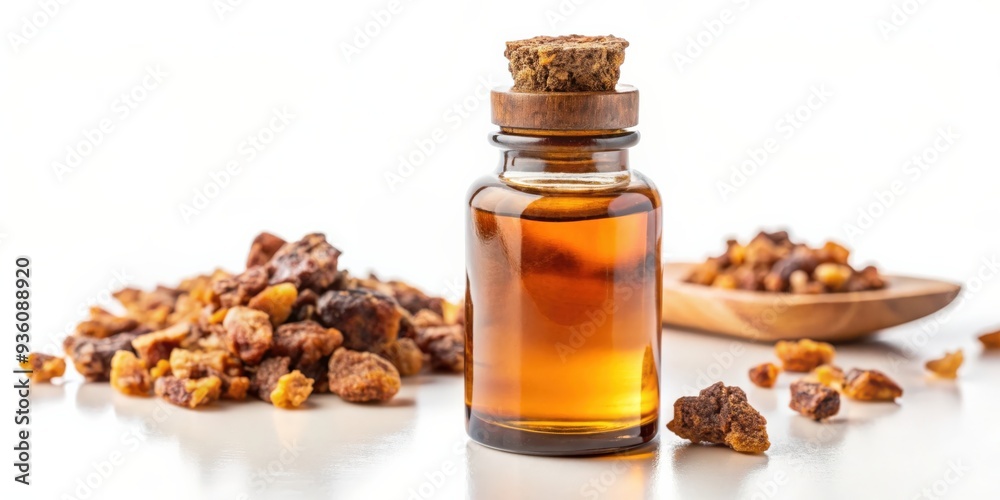 A bottle of myrrh essential oil on a white background A bottle of myrrh essential oil on a white background