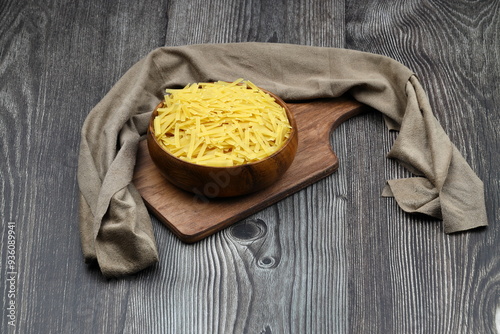 Handmade Turkish Noodles (Turkish Name: Eriste) in bowl. Erishte from Traditional Turkish Cuisine. Vermicelli on wooden background. photo