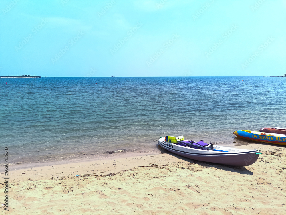 Jepara, Indonesia - August 23, 2024 : View of Blebak Beach in Jepara in the morning and the parked canoes Jepara, Indonesia - August 23, 2024 : View of Blebak Beach in Jepara in the morning and the parked canoes