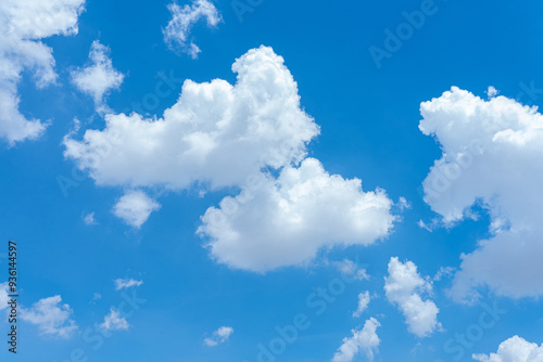 Fototapeta Naklejka Na Ścianę i Meble -  Bright blue sky with fluffy white clouds on a sunny day