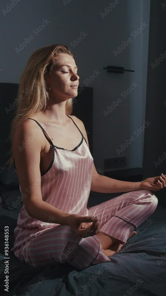 Woman practicing mindfulness meditation in a serene bedroom Woman practicing mindfulness meditation in a serene bedroom