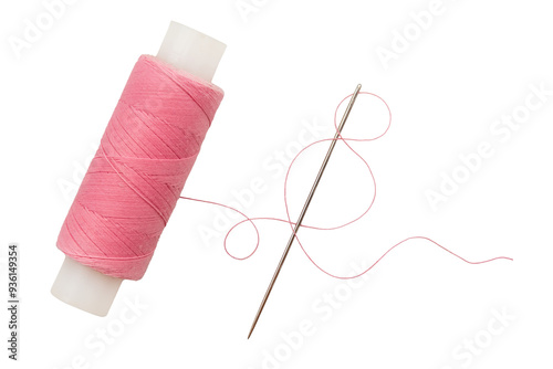 Old spool of thread and needle on a white background. Sewing accessories